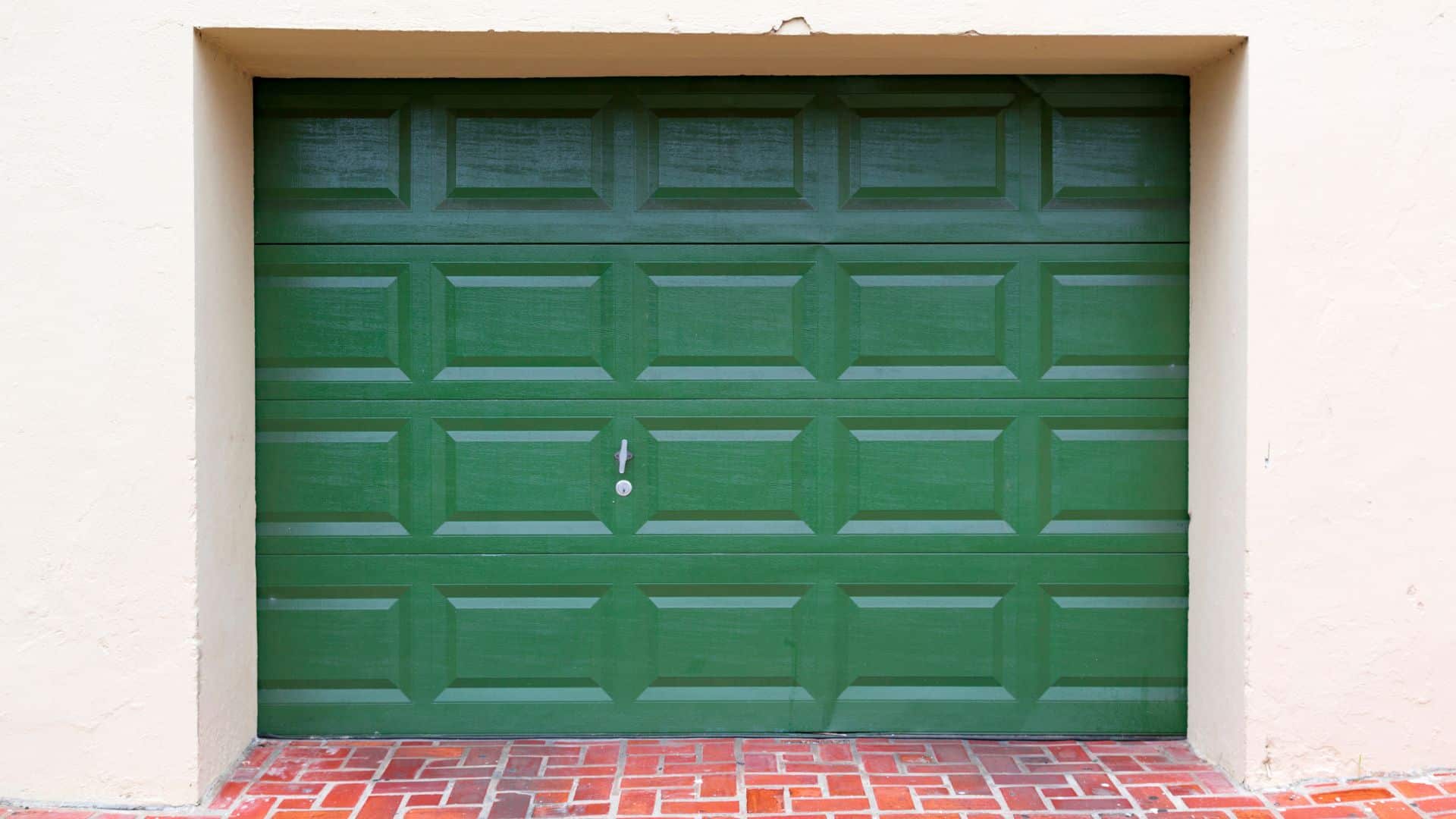 A green wood garage door reinforced by the best garage door insulation 