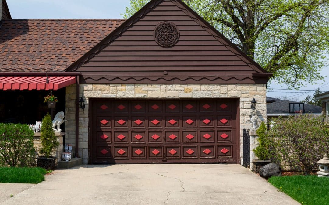 A red and brown garage door featuring garage door decor